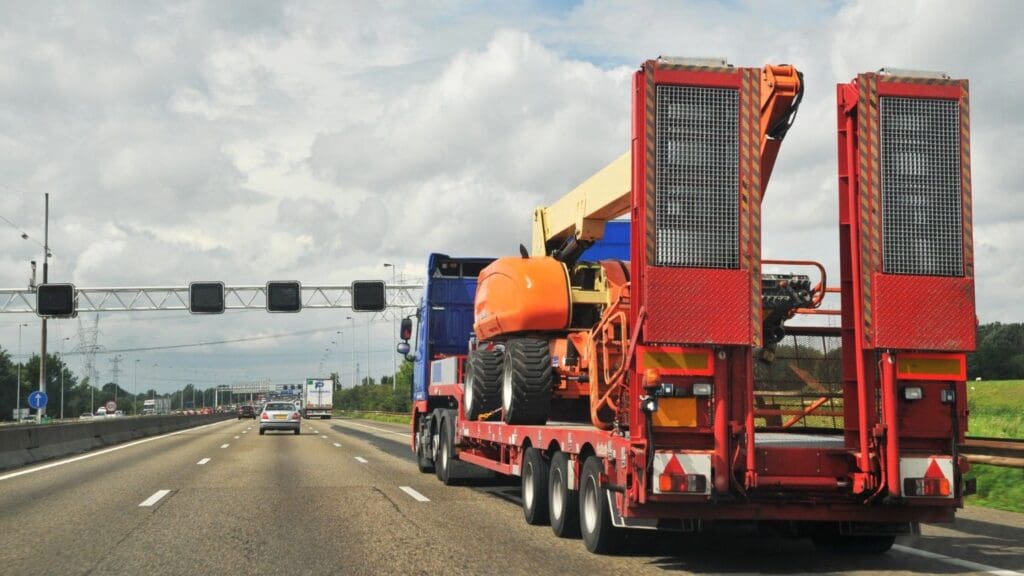 A heavy equipment transport vehicle carrying construction equipment.