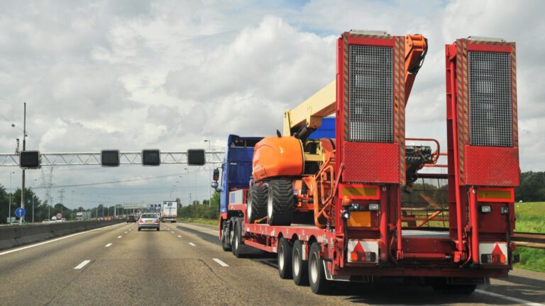 A heavy equipment transport vehicle carrying construction equipment.